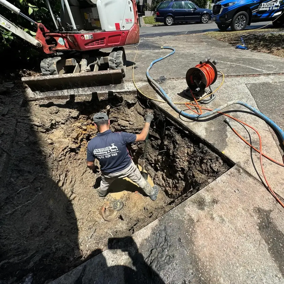 Antons plumber excavating an underground drain for repair