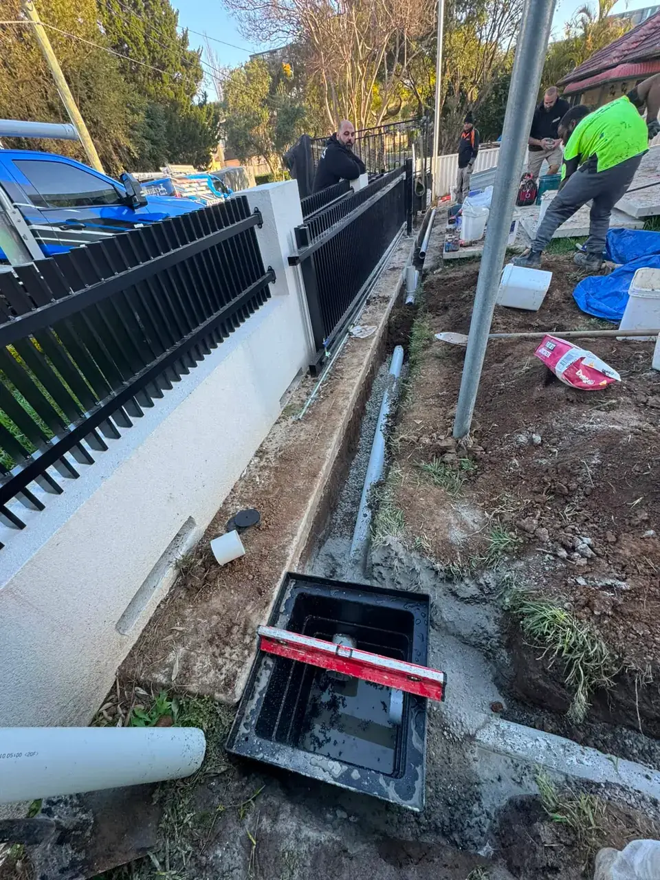 Antons team installing drainage beside a home